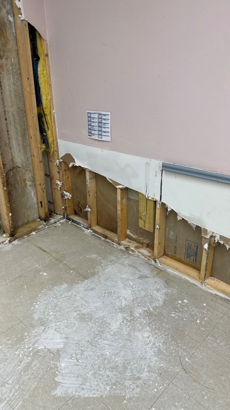 Flood cuts along the wainscot wall of a flooded commercial classroom